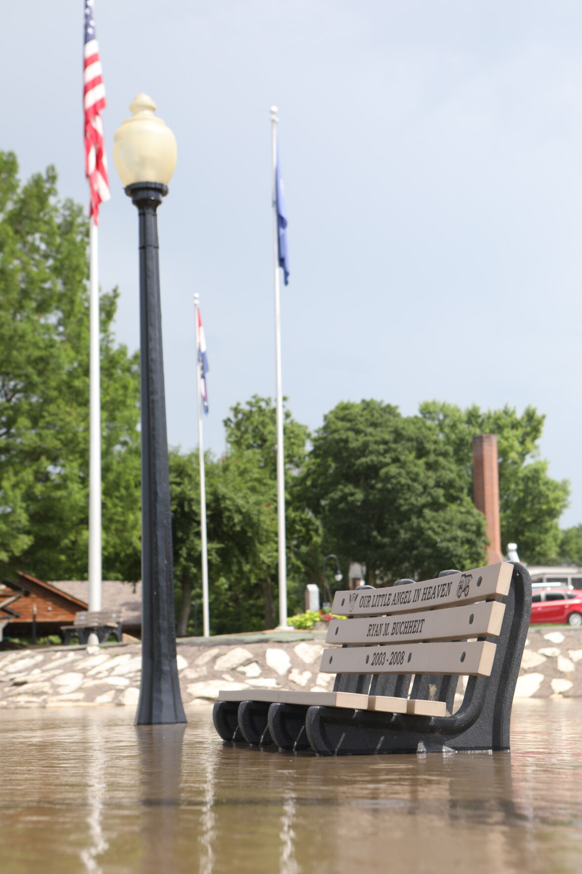 Flood waters creep toward the seat of a bench